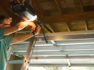 Rectangle-34624455 Professional repairman working on garage door spring
